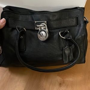Michael Kors black leather satchel with leather and metal chain shoulder strap.